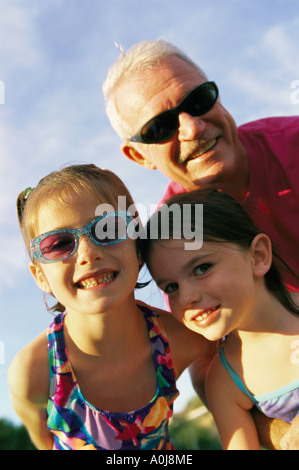 Grandfather posing with granddaughters Stock Photo
