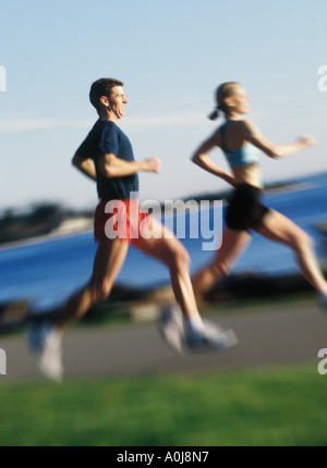 Young man and woman jogging Stock Photo