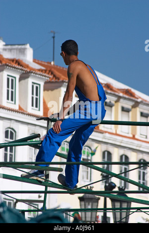 worker sitting on scaffold Stock Photo
