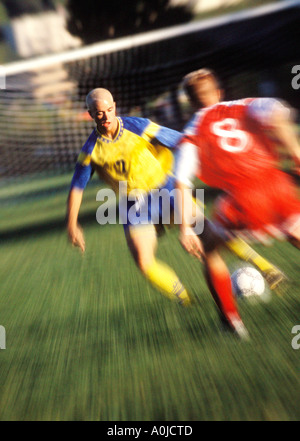 Two young men playing soccer Stock Photo