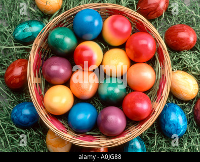 children playing outdoor in garden with painted Easter eggs in a basket Stock Photo