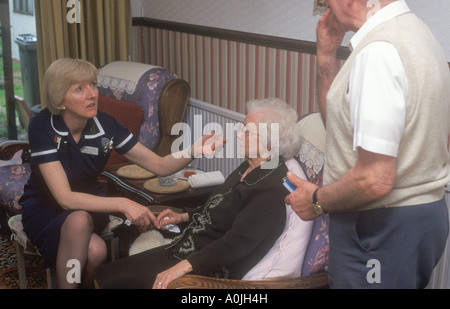 A district nurse visiting an elderly patient at her home, Harrow, London, UK. 4/2003. Stock Photo