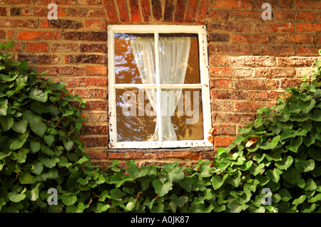 A white framed window on the side of Captain Cook's Cottage, Fitzroy Gardens, Melbourne Australia Stock Photo