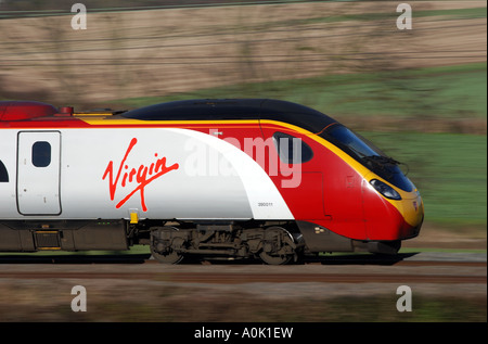 Virgin Pendolino electric train at speed between Coventry and Rugby, Warwickshire, England, UK Stock Photo