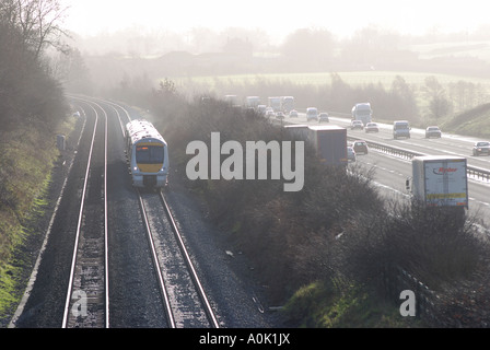 Chiltern Railways train running parallel to M40 motorway, Rowington, Warwickshire, England, UK Stock Photo