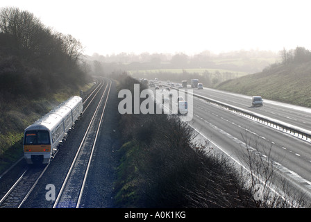 Chiltern Railways train running parallel to M40 motorway, Rowington, Warwickshire, England, UK Stock Photo