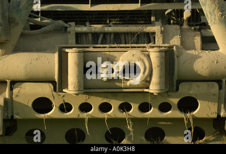 Land Rover Defender front with winch and bull bar totally covered in mud. Stock Photo