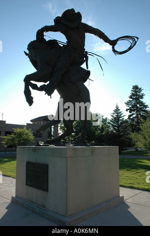 Bronze statue of cowboy on bucking horse sculpted by J.C. Dye Stock ...