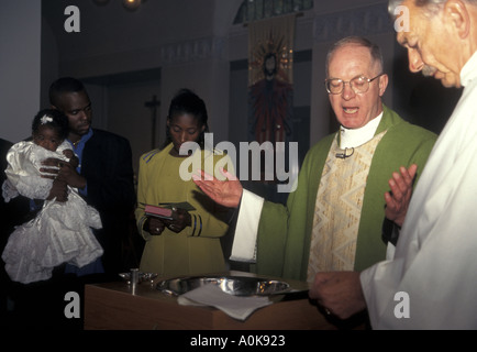 Catholic baptism ceremony with officiating priests London Stock Photo