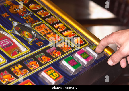 man playing slot machine Stock Photo