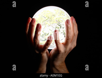 Fortune teller holding a magical glowing crystal ball cradled in her ...
