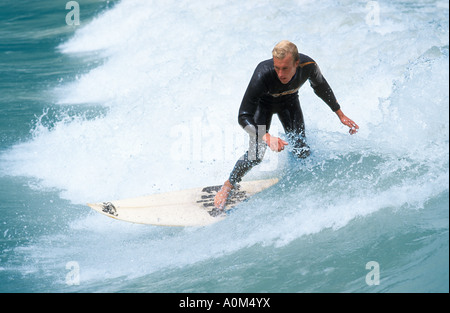 young man surfing on river Isar in the middle of Munich Bavaria Germany Stock Photo