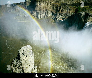 Rainbow glistens above the rushing waters of the Snake River as they pour over Twin Falls of the Snake River in Southern Idaho Stock Photo