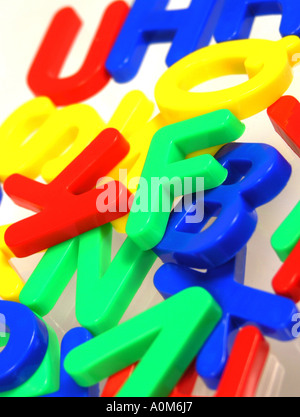 plastic fridge magnet numbers and letters in primary colours Stock Photo