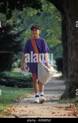 newspaper delivery boy  USA PA Pennsylvania walking newsboy carrier deliver delivery American US United States Stock Photo