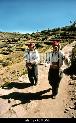 Peru Lake Titicaca Taquile Island islanders knitting whilst walking Stock Photo