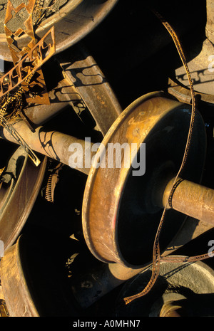 close up detail rust rusted rusting railroad parts wheel junk yard trash pollution environment environmental disaster Stock Photo