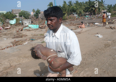Father man holding child son killed in natural disaster Tsunami earthquake on sea floor Nagapattinum Velankanni Tamil Nadu India Stock Photo