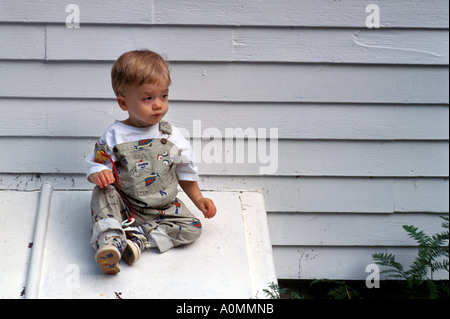 1 one young boy toddler slide sliding down cellar door copy space