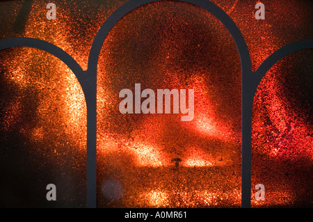 patterns of carbon on the fireglass of a wood burning stove Stock Photo