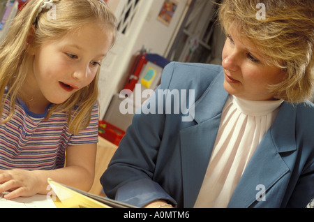 teacher administrator administrative young female girl student interact interaction Stock Photo