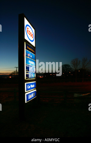 Esso filling station sign showing petrol and diesel prices at dusk