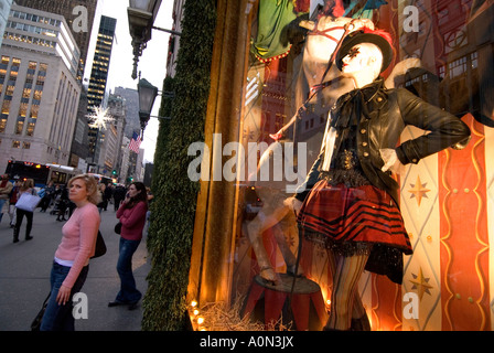Shoppers pass Christmas window display at Bergdorf Goodman department store on 5th Avenue in Uptown Manhattan New York USA Stock Photo