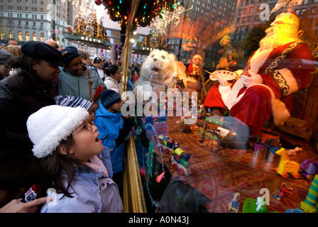 Child looking at Christmas window display from Macy s department store in midtown Manhattan New York USA Stock Photo