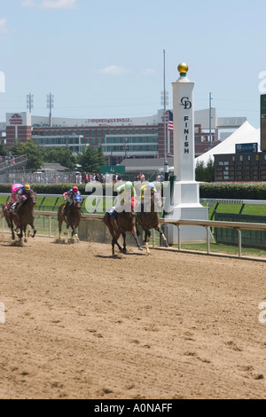 Race horses crossing the finish line at Churchill Downs during race Stock Photo