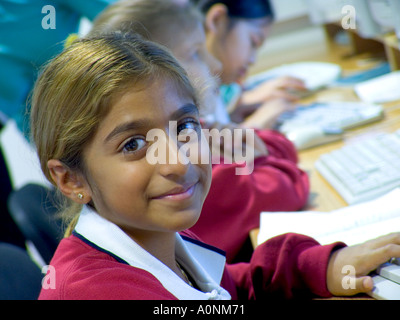Confident junior schoolgirl pupil in school computer class Stock Photo