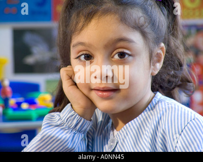 Close-up portrait of cute smiling girl sitting on swing in yard Stock ...