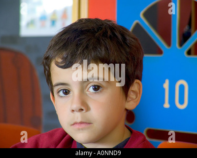 Infant boy with number 10 in background on play classroom kindergarten door Stock Photo