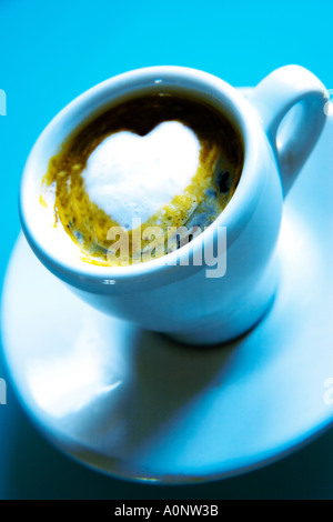COFFEE FILLED CUP WITH HEART SHAPED FROTH Stock Photo