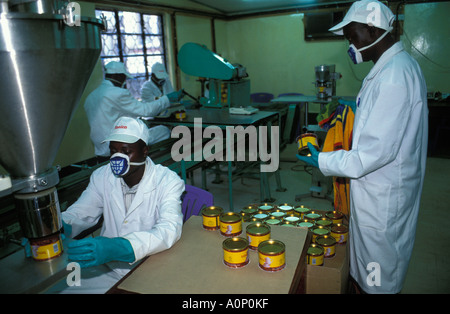 Bukoba workers measuring the exact amount of instant coffee at the Tanica factory which is owned by the KCU cooperation Stock Photo