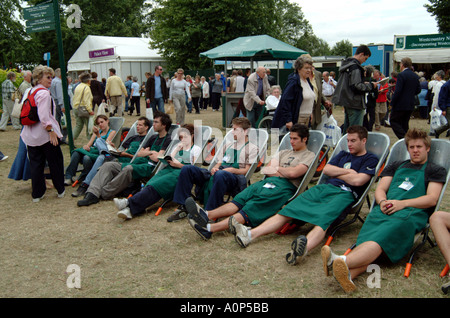Boys and Girls seated in Wheelbarrows used to transport purchases to your car at Hampton Court Flower Show grounds west London Stock Photo