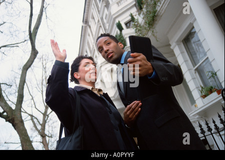 Close-up of man and woman city executives in London street. Stock Photo