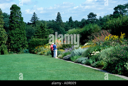 Visitors view the mixed flower borders from the lawns of the Royal Horticultural Society s show gardens at Wisley in Surrey UK Stock Photo