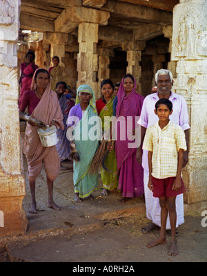 Group of women man & boy in colourful traditional clothing looking after ancient temples - Hampi Karnataka India South Asia Stock Photo