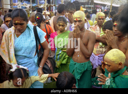 Group decorated painted head colourful Hindu people women children boy pray passionately Palani Tamil Nadu India South Asia Stock Photo