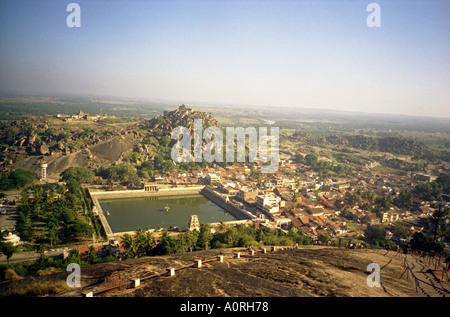Panoramic view old ancient city ruins Hindu temple green hill purifying square water pool Hampi Karnataka India South Asia Stock Photo