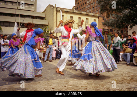 African man & woman dancers perform together outdoor in colourful traditional clothing Bogotá Colombia South Latin America Stock Photo
