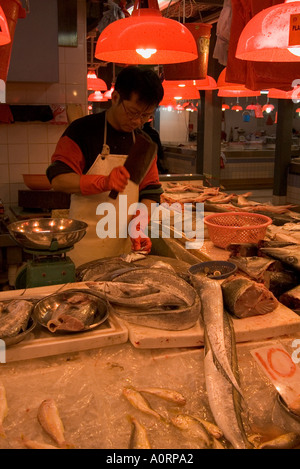 dh Fish markets stall shop TAIPO WET MARKET HONG KONG NT Fishmonger chopping shopkeeper preparing food china tai po New indoor Stock Photo