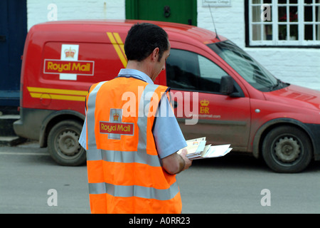 royal mail postman delivers letters in rural location England UK Royal Mail Stock Photo