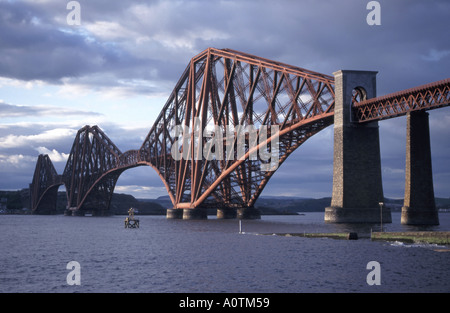 Historical Victorian Firth of Forth steel cantilever rail bridge late evening sunshine at dusk South Queensferry view to North Queensferry Scotland UK Stock Photo