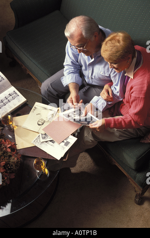Senior couple looking at photographs Stock Photo