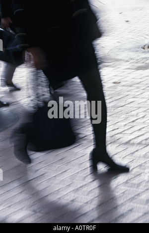 Businesswoman rushing down street Stock Photo