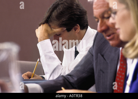 Caucasian businessman making notes during meeting Stock Photo