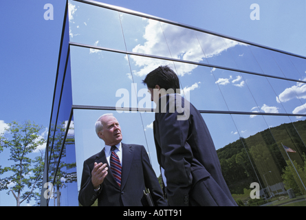 Visionary Senior executive with real estate developer in front of a new modern commercial office building Stock Photo