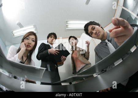 Low angle view of two businessmen and two businesswomen Stock Photo