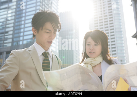 Close up of a male and a female architect looking at a blueprint Stock Photo